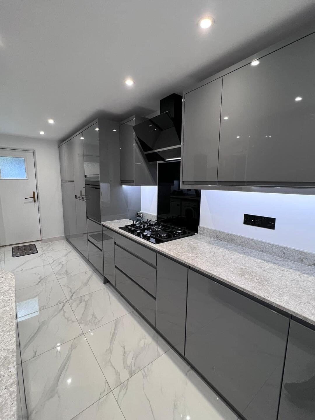 High-gloss gray kitchen renovation with marbled tile flooring