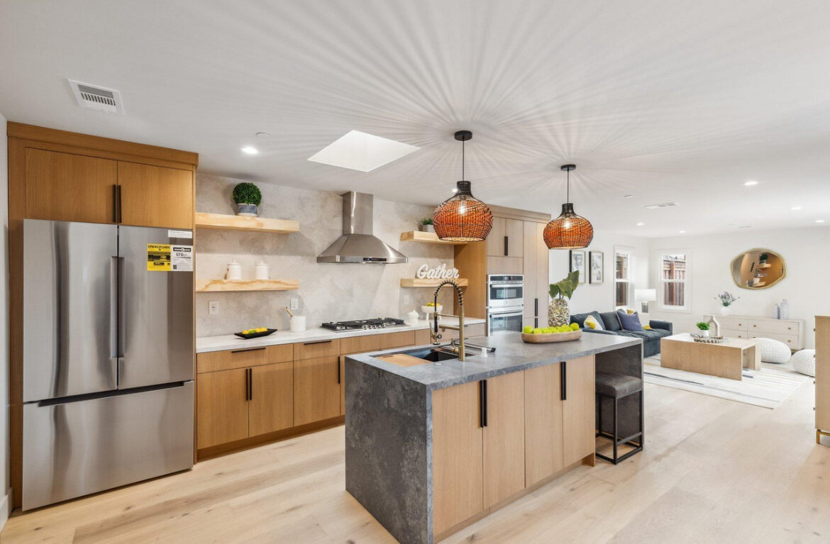 Wood and black stone kitchen renovation opening into the living room